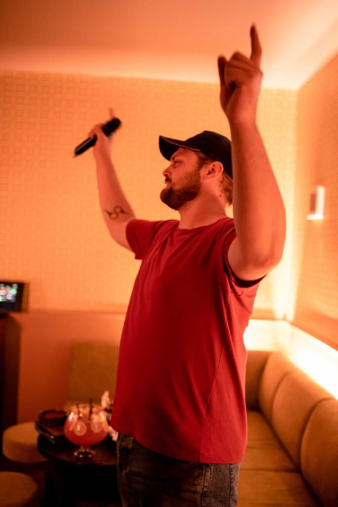 Person having fun singing in the karaoke rooms