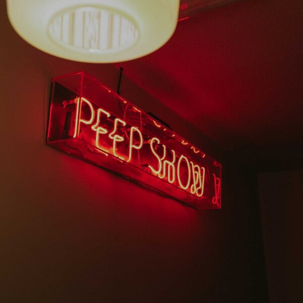 Red neon peep show sign for decorative purposes