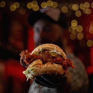 Food offers. A freshly cooked burger held by the Hefty Hen chef, photographed as part of a midweek food offers.